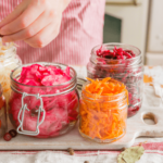 jars containing colorful vegetables are arranged on a counter