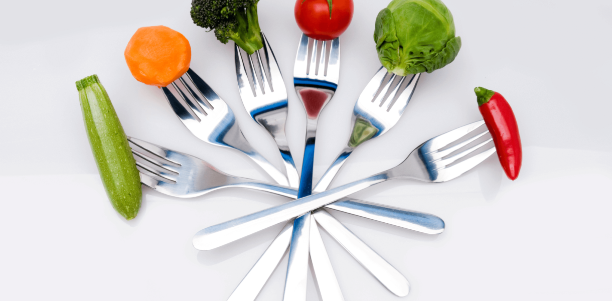 vegetables are held by forks in an arc shape