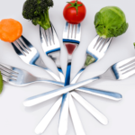 vegetables are held by forks in an arc shape