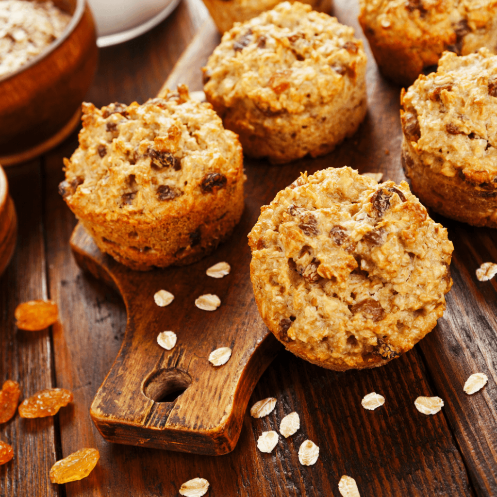 muffins are set on a board with oats and raisins