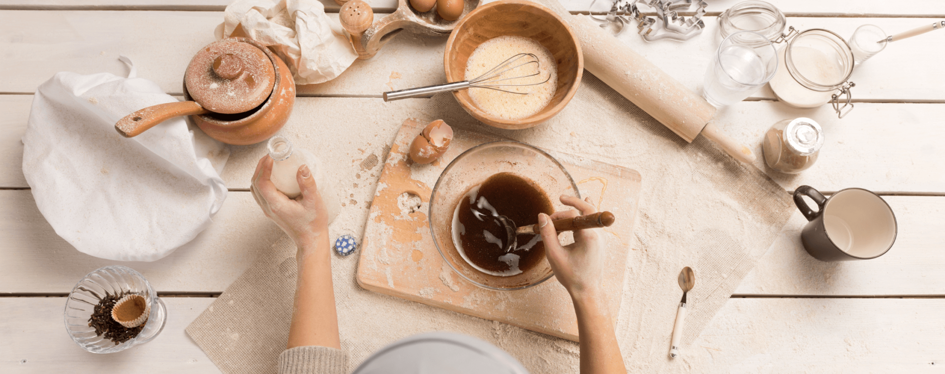 a person stands before ingredients and tools set out for baking